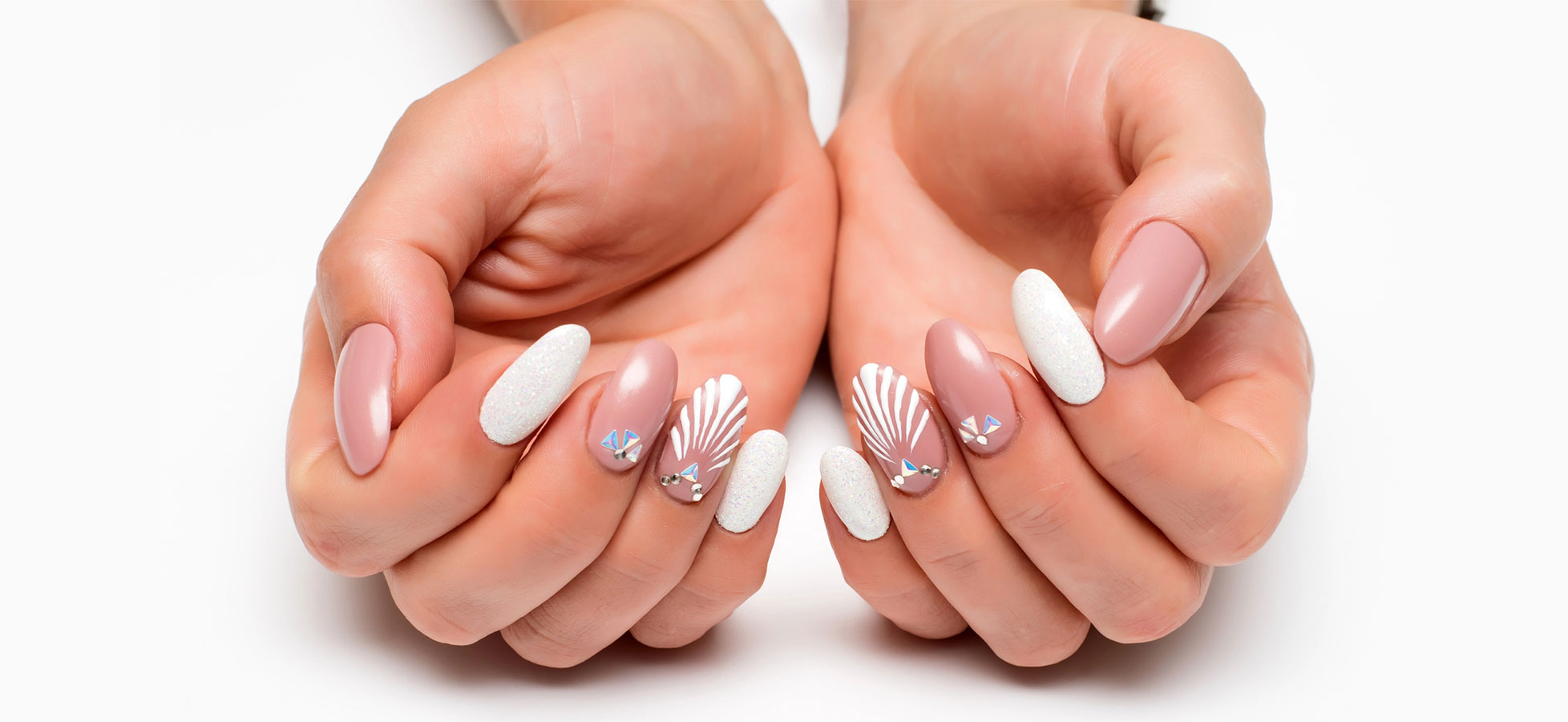 Editorial flat-lay of manicured hands on white marble